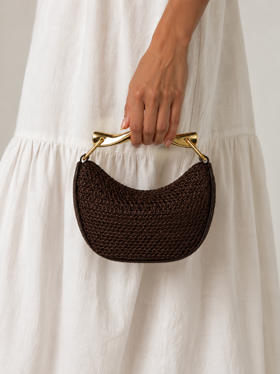 Bolso trenzado Veska con asa metálica, diseño elegante y moderno, hecho de material resistente y con detalles en la parte superior.