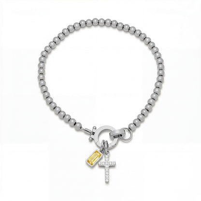 Pulsera Veska con dije de cruz y piedra natal en joyería de plata, con detalles elegantes y estilo sofisticado.