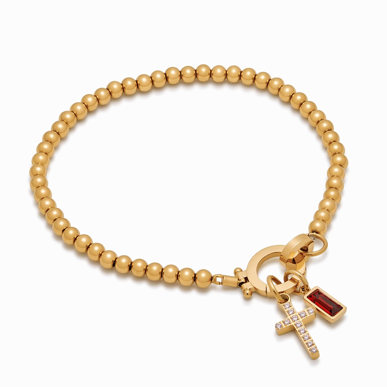 Pulsera de Veska con dije de cruz y piedra natal, accesorio de joyería con detalles delicados y significado simbólico.